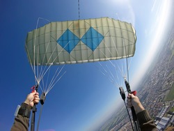 Point of view of skydiver piloting his parachute. Fish eye lens used. Sunshine right image .