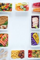 Prepared food delivery concept. Top view of assorted ready to eat meals over white background with copy space.