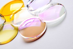 Round lenses for glasses with anti-reflective coating on a white background. Production of glasses and spectacle lenses.