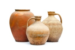Antique ceramic decorative amphora on a white background. Clay jugs and a pot, a set of ancient utensils for drinking wine, water or milk.