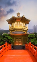 Golden buddhism tower with red bridge and blue sky in China.
