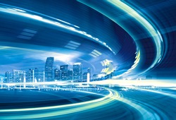 Abstract Illustration of an urban highway going to the modern city downtown, speed motion with colorful light trails.