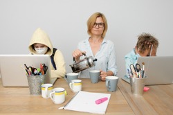 the photo of the situation when mom and kids during the covid time having the home schooling
