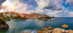 Panorama of Harbour with vessels, boats, beach and lighthouse in Bali at sunrise, Rethymno, Crete, Greece. Famous summer resort in Bali village, near Rethimno, Crete, Greece. 