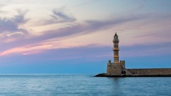 Panorama of venetian harbour waterfront and lighthouse in old harbour of Chania, Crete, Greece. Old venetian lighthouse in Chania, Greece. Lighthouse of the old Venetian port in Chania, Greece.