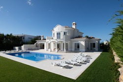 Exterior of luxury Holiday Villa with blue sky and beautiful swimming pool