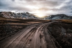 Beautiful Landmanalaugar gravel dust road way on highland of Iceland, Europe. Muddy tough terrain for extreme 4WD 4x4 vehicle. Landmanalaugar landscape is famous for nature trekking and hiking.