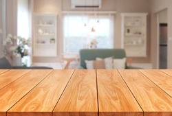 Wood table in modern home room interior with empty copy space on the table for product display mockup. Furniture design and home decoration concept.