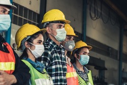 Quarantined masked workers protect spreading of Covid 19 by wearing face masks. Coronavirus Disease or COVID can spread easily without mask. Workers are advised to wear masks during quarantine time.