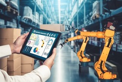 Smart robot arm systems for innovative warehouse and factory digital technology . Automation manufacturing robot controlled by industry engineering using IOT software connected to internet network .