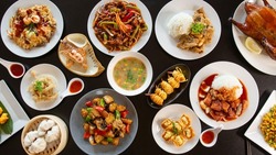 Top view food platter combo set of traditional Cantonese yum-cha Asian gourmet cuisine meal food dish on the white serving plate on the table, includes dishes of duck, pork, fish, chicken, vegetables