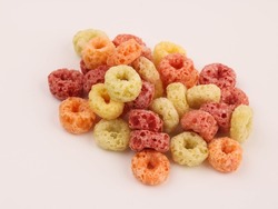 Delicious and nutritious fruit cereal loops flavorful on white background, healthy and funny addition to kids breakfast, cereal loops, fruity cereal, fruit cereal, meal