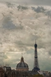 L’Institut de France and the Eiffel Tower in front of impressionist clouds, seen from pont Neuf.