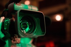 A video camera front lens during a live event.