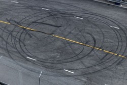 Tire tracks texture and background, Asphalt texture with line and tire marks, Automobile automotive tire skid mark on race track, Abstract texture car drift tire skid mark.