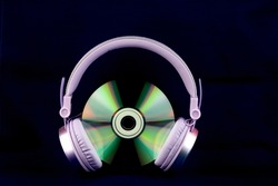 CD and headphones isolated on a Blue Background