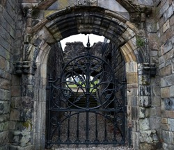 Iron gate in a medieval ruined cemetery entrance in Stirling Scotland