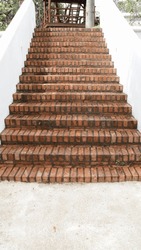 Outdoor bricks stair step and white wall.