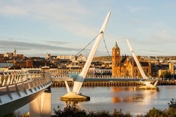 The Peace Bridge over the River Foyle and Guildhall in Derry City
