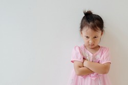 Copy space and portrait Asian girl 3 year old punished. Asia kid cross her arm and making angry face. Concept punish kid and time out limit, Rule and punishment, problem and handle, terrible two