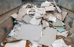 Construction waste and drywall material in one container