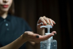 hands using wash hand sanitizer gel pump dispenser. Clear sanitizer in pump bottle, for killing germs, bacteria and virus.