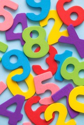 Close up of multicolored wooden numbers back to school abstract.
