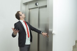 Businessman is confused because the elevator does not work