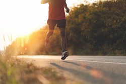 Athlete runner feet running on road, Jogging concept at outdoors. Man running for exercise.