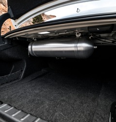 Aftermarket air tank for air ride suspension in the trunk of a car
