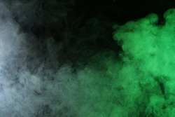 Artificial smoke in red-green light on black background