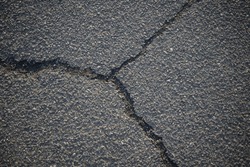 asphalt cracks, pavement destruction, patched asphalt texture of white paint for road marking on asphalt, texture of painted asphalt cracked texture white background, white background on gray wall