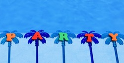 Party on the blue background of the pool. Festive decoration of a palm tree on a background of blue water.