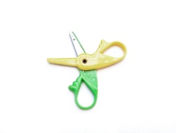 Green-Yellow scissors isolated on a white background.
