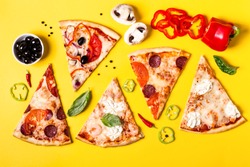 selection of Assorted pieces pizza on yellow background and ingredients. Pepperoni, Vegetarian and Seafood Pizza.