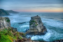 Sunset of the Gannet Rock at Murwai Beach, West Coast, Auckland, New Zealand