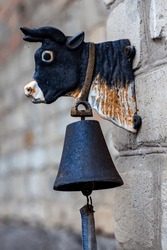 Mount for a bell on the wall in the shape of a cow
