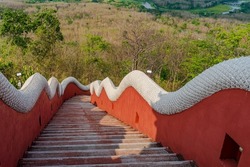 Stairway decorated on both sides with beautiful white stucco of the long body with scale of Serpent, from the temple on the top of a mountain down to the plain below