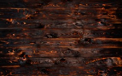 Burnt wooden board, black charcoal wood texture, burned coal barbecue background with copy space, top view