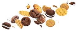 Collection of falling cakes, cookies, crackers, waffles isolated on white background with clipping path. Delicious flying whole and broken sweet biscuits set