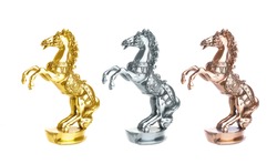 Statuette of horse isolated on white. Gold, silver and bronze statue trophy on horse racing