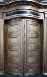 Large curved brass closed doors on a bank entrance