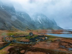 Aerial view of a viking village on a stormy rainy day near Stokksnes under Vestrahorn mountain, Iceland.