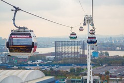 Cable cars from Emirates going above Thames river in London