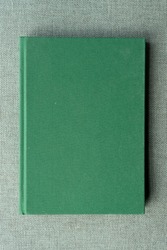 Green blank book on the fabric. Book texture, background