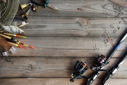 Fishing tackle background. Lifestyle. Spinning, hooks. Accessories for fishing on the wooden background. . Active hobby recreation concept. Top view, flat lay.