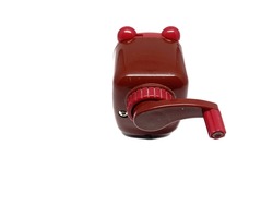 Cute brown rotary pencil sharpener on isolated white background.