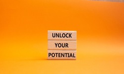 Unlock your Potential symbol. Wooden blocks with words Unlock your Potential. Beautiful orange background. Business and Unlock your Potential concept. Copy space.