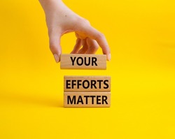 Your Effort Matter symbol. Wooden blocks with words Your Effort Matter. Beautiful yellow background. Businessman hand. Business and Your Effort Matter concept. Copy space. Conceptual image