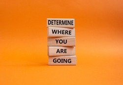 Determination symbol. Wooden blocks with words Determine where you are going. Beautiful orange background. Business and Determine where you are going concept. Copy space